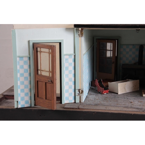 1131 - A LARGE EDWARDIAN DOLLS HOUSE fully fitted with furniture - on a stand 101cm wide 78cm deep