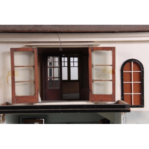 1131 - A LARGE EDWARDIAN DOLLS HOUSE fully fitted with furniture - on a stand 101cm wide 78cm deep