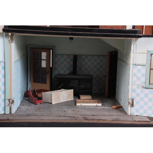 1131 - A LARGE EDWARDIAN DOLLS HOUSE fully fitted with furniture - on a stand 101cm wide 78cm deep