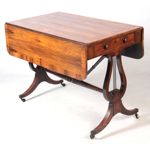 1132 - AN UNUSUAL REGENCY OLIVE WOOD SOFA TABLE the hinged top having a cross-banded edge and two end drawe... 