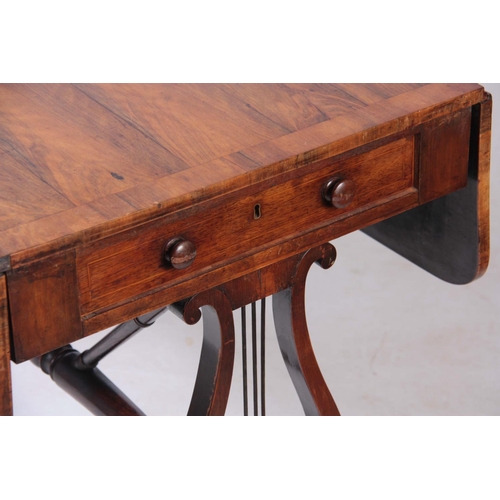 1132 - AN UNUSUAL REGENCY OLIVE WOOD SOFA TABLE the hinged top having a cross-banded edge and two end drawe... 