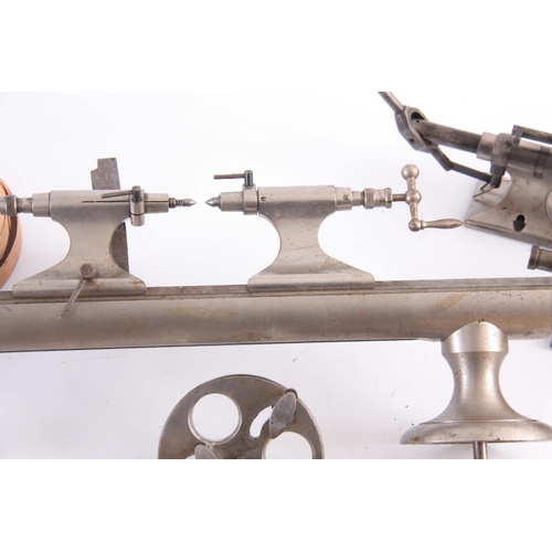 943 - A VINTAGE STEEL WATCHMAKERS LATHE with wheel cutting attachments and various components  42cm wide