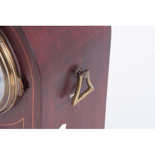 945 - AN EARLY 20th CENTURY ARCHED TOP MAHOGANY MANTEL CLOCK with inlaid decoration and convex porcelain d... 