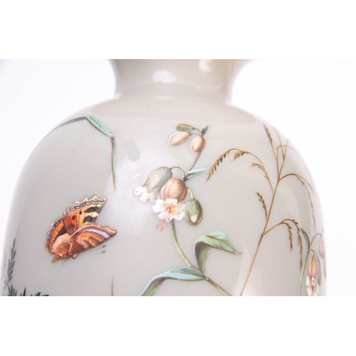 13 - AN EARLY 20TH CENTURY FRENCH OPAQUE GLASS VASE decorated with enamel butterflies amongst flowers 23c... 