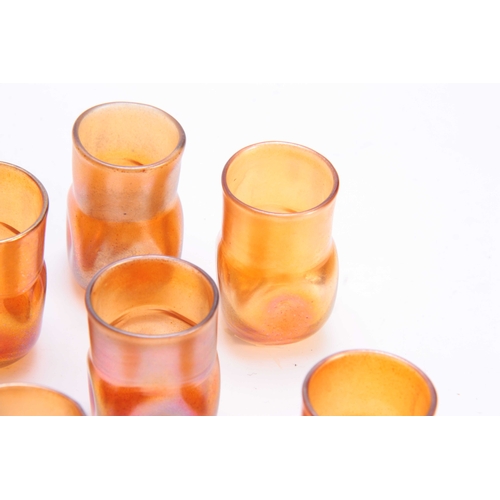 15 - A SET OF TEN TIFFANY FAVRILE SHOT GLASSES with square dimple bodies and plain necks 5cm high - signe... 