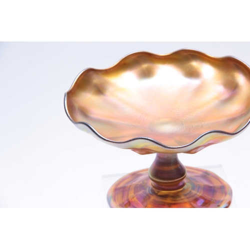 17 - A TIFFANY, FAVRILE IRIDESCENT GLASS FOOTED COMPOTE with baluster stem, panelled foot and bowl with s... 