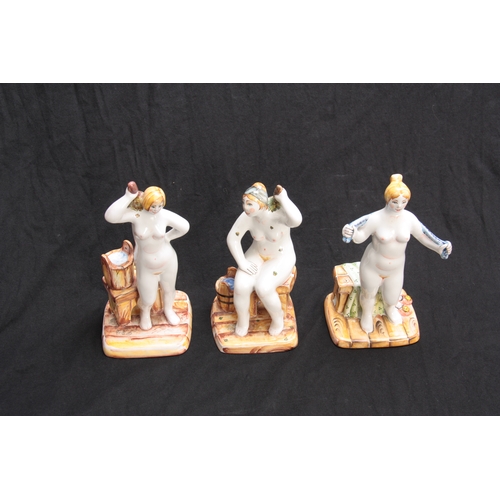 100 - A GROUP OF THREE RUSSIAN GLAZED TERRACOTTA NUDE FEMALE BATHERS 19cm high  and smaller