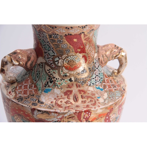 111 - A LARGE SATSUMA TAPERING SHOULDERED VASE WITH ELEPHANTS HEAD SIDE HANDLES colourfully decorated with... 