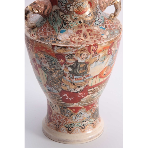 111 - A LARGE SATSUMA TAPERING SHOULDERED VASE WITH ELEPHANTS HEAD SIDE HANDLES colourfully decorated with... 