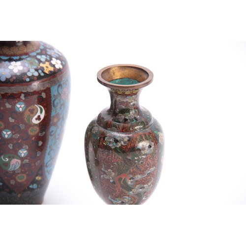 134 - A PAIR OF CHINESE CLOISONNE ENAMEL TAPERING SHOUDERED FOOTED VASES with dragon work and delicate flo... 