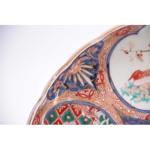 142 - A 19TH CENTURY IMARI SCALLOP EDGED DISH colourfully decorated with birds and floral decoration, sign... 