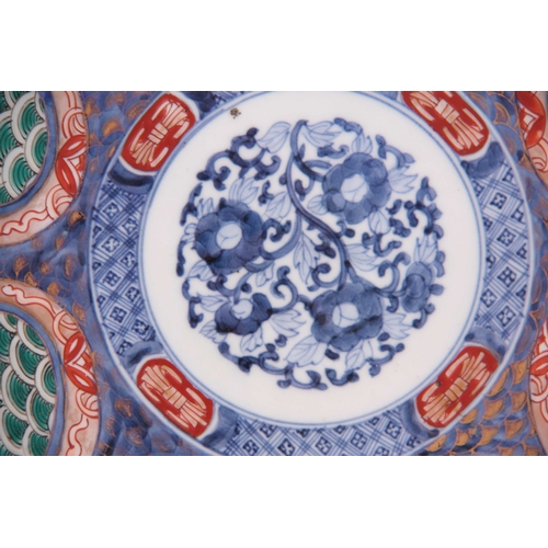 142 - A 19TH CENTURY IMARI SCALLOP EDGED DISH colourfully decorated with birds and floral decoration, sign... 