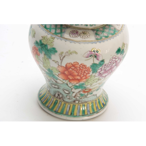 151 - A CHINESE FAMILLE VERTE BULBOUS SHAPED LIDDED VASE decorated with flower sprays 17.5cm high.