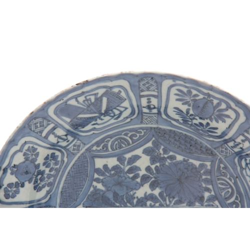 152 - A PAIR OF 17TH CENTURY CHINESE BLUE AND WHITE DISHES decorated with panels of flowers and antiquitie... 