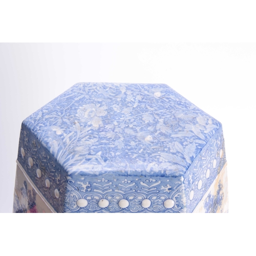 159 - A CHINESE BLUE AND WHITE HEXOGANOL GARDEN SEAT with leaf and flower head decorated top above a tree-... 