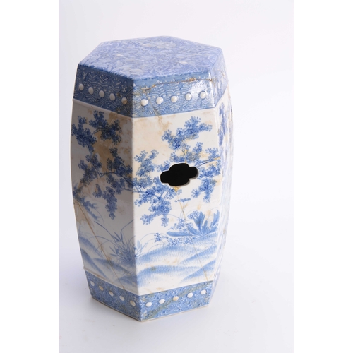 159 - A CHINESE BLUE AND WHITE HEXOGANOL GARDEN SEAT with leaf and flower head decorated top above a tree-... 