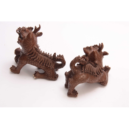 162 - A PAIR OF CHINESE TERRACOTTA DOGS OF FO with cream glazed eyes and teeth - signed with seal marks un... 