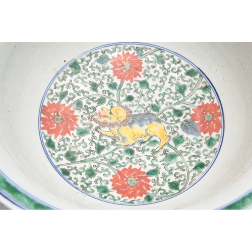 165 - A 19TH CENTURY CHINESE FAMILLE VERTE PUNCH BOWL decorated with colourful foo dogs amongst flowers 43... 