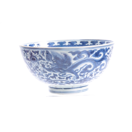 166 - AN 18th/19th CENTURY CHINESE BLUE AND WHITE DEEP FOOTED BOWL bearing KANGXI marks with cavorting dra... 