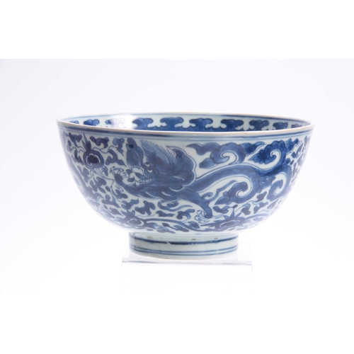 166 - AN 18th/19th CENTURY CHINESE BLUE AND WHITE DEEP FOOTED BOWL bearing KANGXI marks with cavorting dra... 