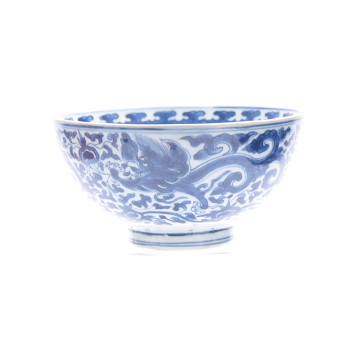 166 - AN 18th/19th CENTURY CHINESE BLUE AND WHITE DEEP FOOTED BOWL bearing KANGXI marks with cavorting dra... 