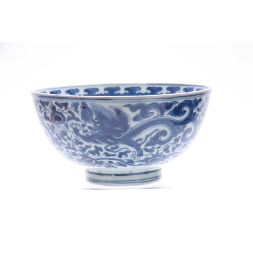 166 - AN 18th/19th CENTURY CHINESE BLUE AND WHITE DEEP FOOTED BOWL bearing KANGXI marks with cavorting dra... 