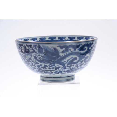 166 - AN 18th/19th CENTURY CHINESE BLUE AND WHITE DEEP FOOTED BOWL bearing KANGXI marks with cavorting dra... 