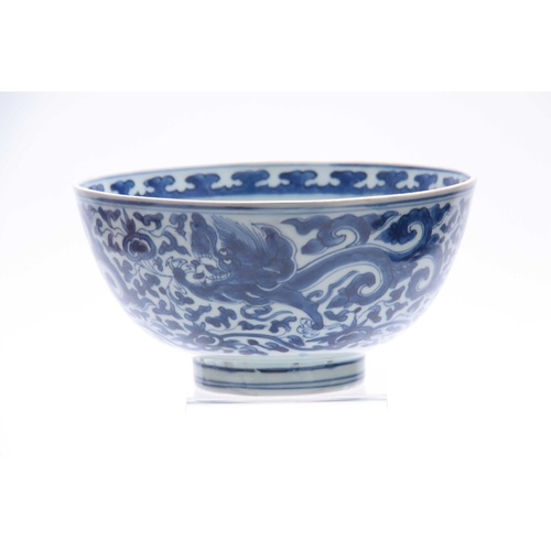 166 - AN 18th/19th CENTURY CHINESE BLUE AND WHITE DEEP FOOTED BOWL bearing KANGXI marks with cavorting dra... 