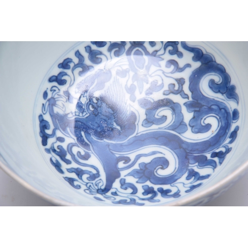 166 - AN 18th/19th CENTURY CHINESE BLUE AND WHITE DEEP FOOTED BOWL bearing KANGXI marks with cavorting dra... 