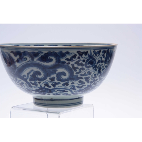 166 - AN 18th/19th CENTURY CHINESE BLUE AND WHITE DEEP FOOTED BOWL bearing KANGXI marks with cavorting dra... 