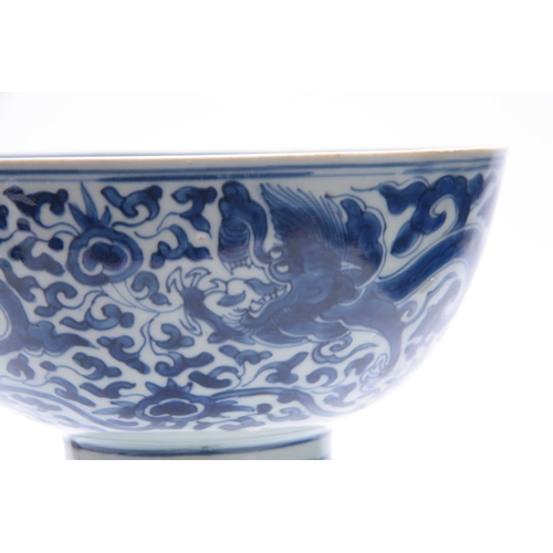 166 - AN 18th/19th CENTURY CHINESE BLUE AND WHITE DEEP FOOTED BOWL bearing KANGXI marks with cavorting dra... 