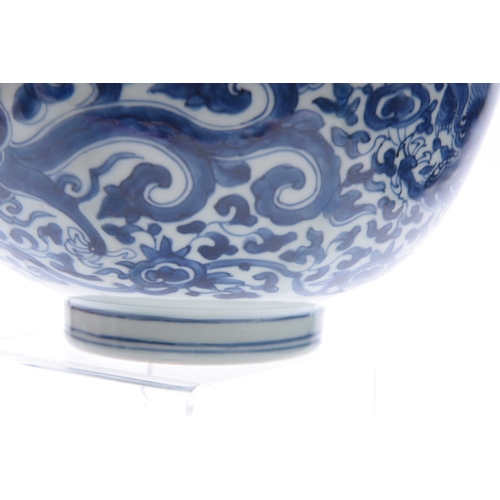 166 - AN 18th/19th CENTURY CHINESE BLUE AND WHITE DEEP FOOTED BOWL bearing KANGXI marks with cavorting dra... 