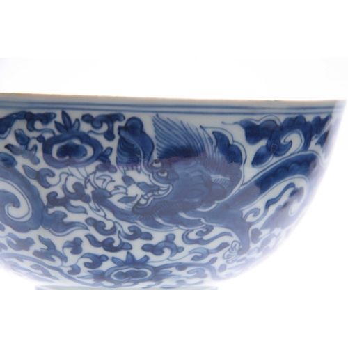 166 - AN 18th/19th CENTURY CHINESE BLUE AND WHITE DEEP FOOTED BOWL bearing KANGXI marks with cavorting dra... 