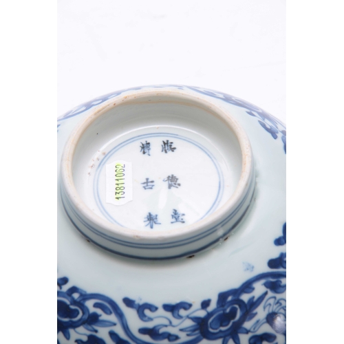 166 - AN 18th/19th CENTURY CHINESE BLUE AND WHITE DEEP FOOTED BOWL bearing KANGXI marks with cavorting dra... 