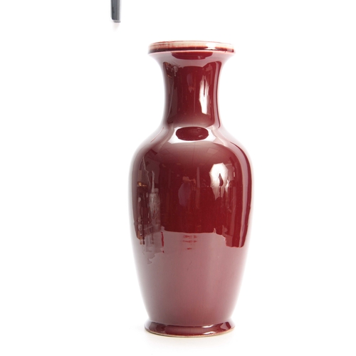 186 - A 20TH CENTURY CHINESE SANG DE BOEUF VASE with flared neck and bulbous body 48cm high.