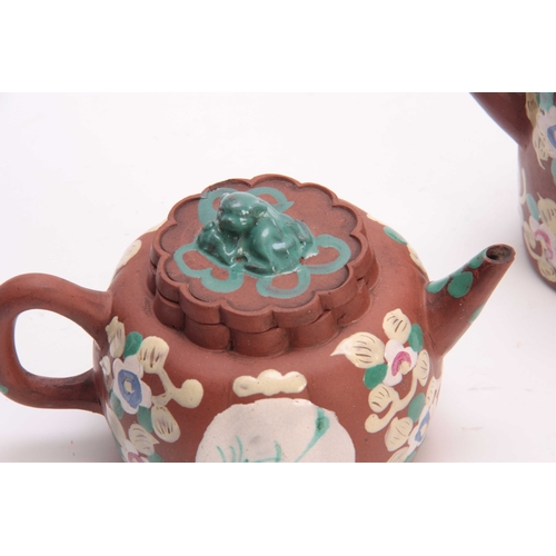 189 - TWO CHINESE REPUBLIC PERIOD REDWARE TEAPOTS the squat rounded example enamelled with floral and meda... 