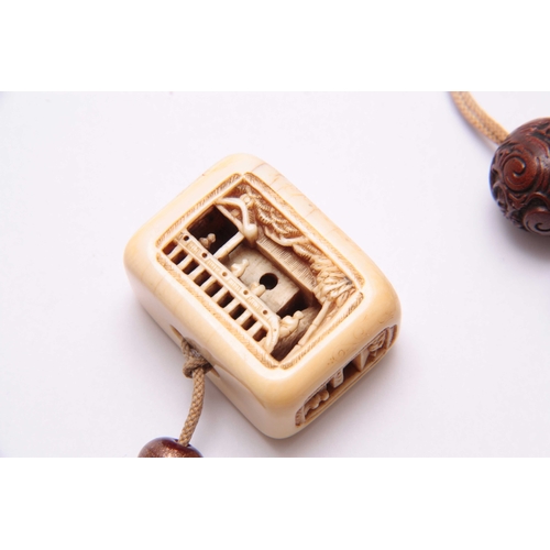 192 - A LATE 19TH CENTURY JAPANESE CARVED IVORY NETSUKE finely carved with figures in a room setting - sig... 