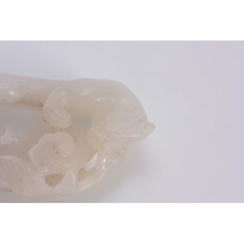 199 - A CHINESE CARVED WHITE JADE SCULPTURE depicting a Leopard climbing a rock 6cm overall 3cm wide.