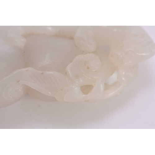 199 - A CHINESE CARVED WHITE JADE SCULPTURE depicting a Leopard climbing a rock 6cm overall 3cm wide.