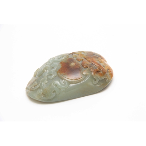 203 - A CHINESE RUSTIC JADE CARVED PAPERWEIGHT having raised scrollwork decoration with a knobled textured... 