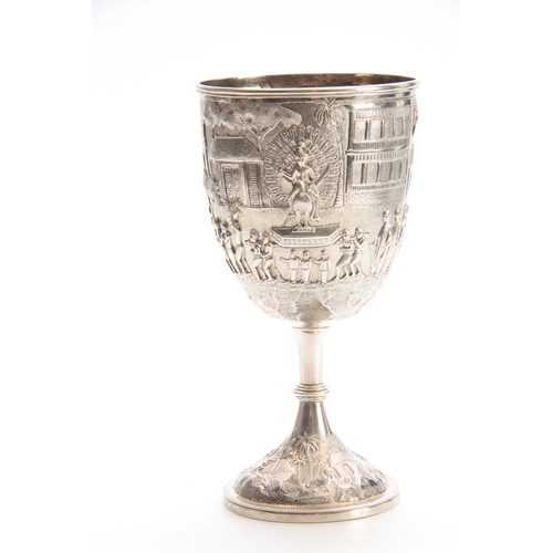 210 - A LARGE INDIAN SILVER GOBLET with gilt interior and embossed decoration with Indian god sat on a pea... 