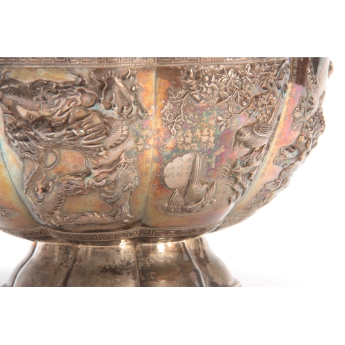 211 - A LARGE CHINESE SILVER BOWL with gilt interior having embossed foliate panels depicting birds, butte... 