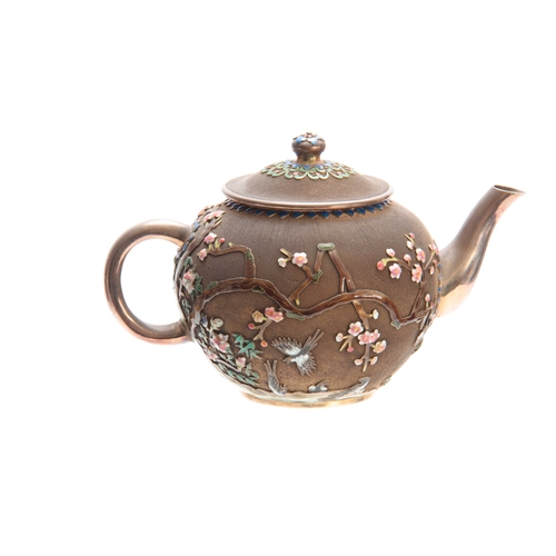 212 - AN EARLY 20th CENTURY SILVER AND ENAMEL TEAPOT having a honeycomb-style finish overlaid with enamel ... 