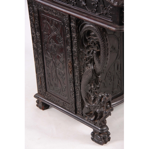 224 - A 19TH CENTURY CARVED HARDWOOD DAVENPORT with carved figural gallery above an angled leather writing... 