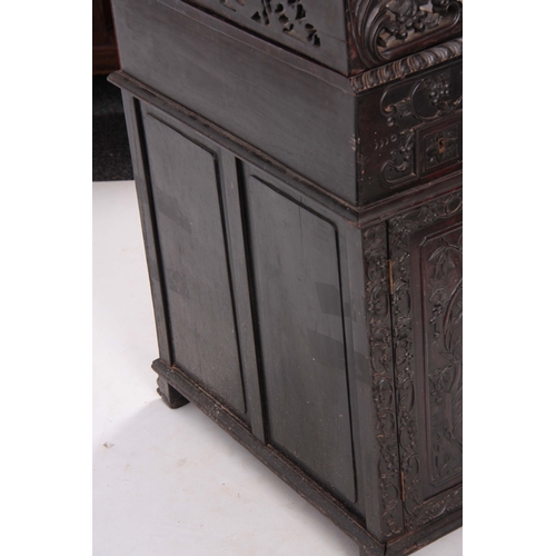 224 - A 19TH CENTURY CARVED HARDWOOD DAVENPORT with carved figural gallery above an angled leather writing... 