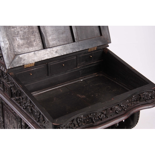 224 - A 19TH CENTURY CARVED HARDWOOD DAVENPORT with carved figural gallery above an angled leather writing... 