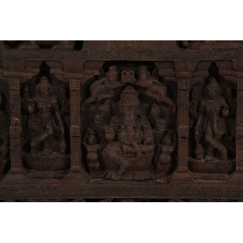 226 - A LATE 19TH CENTURY INDIAN WALL PANEL finely carved with figures amongst temples 198cm wide 100cm hi... 