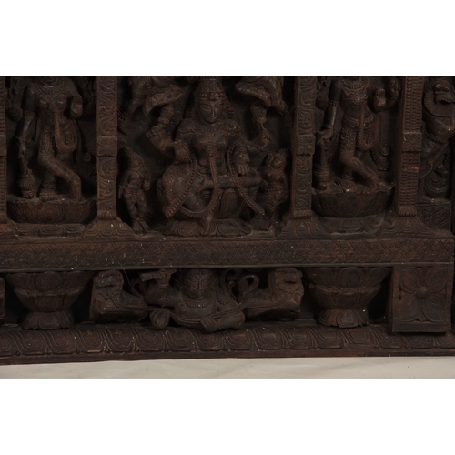 226 - A LATE 19TH CENTURY INDIAN WALL PANEL finely carved with figures amongst temples 198cm wide 100cm hi... 