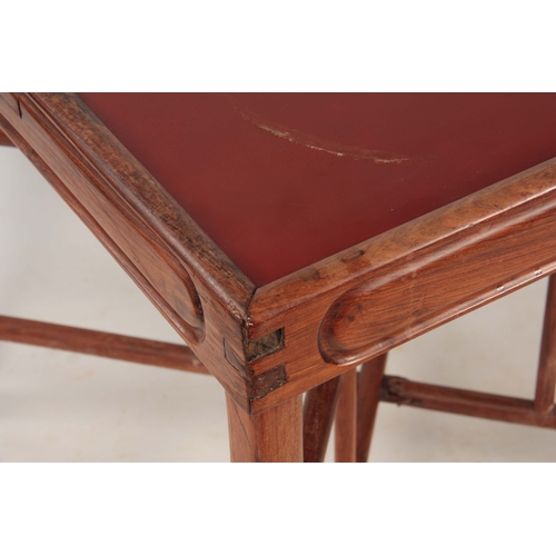 231 - A 19TH CENTURY CHINESE HARDWOOD GAMES TABLE with square red lacquered top and small frieze drawers t... 