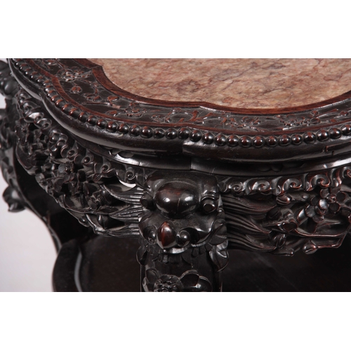 232 - A 19TH CENTURY CHINESE HARDWOOD JARDINIERE STAND with inset shaped marble top, above floral pierced ... 